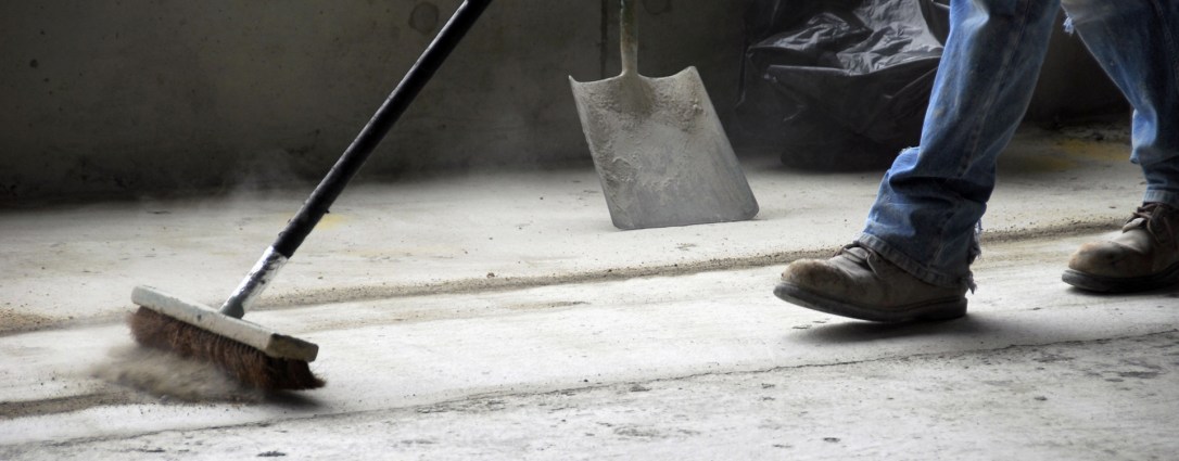 Man cleaning house under construction.